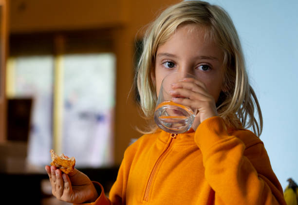 istock Boy eating pizza and drinking water 1777907541