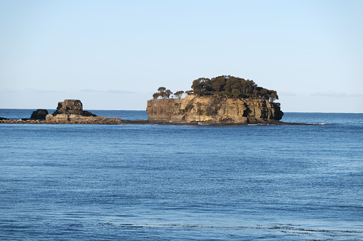 Small rocky island off Pirate Bay at Eaglehawk Neck, on the Tasman Peninsula of Tasmania.