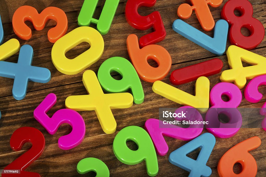 Colorful plastic numbers Colorful plastic numbers on a wooden table Blue Stock Photo