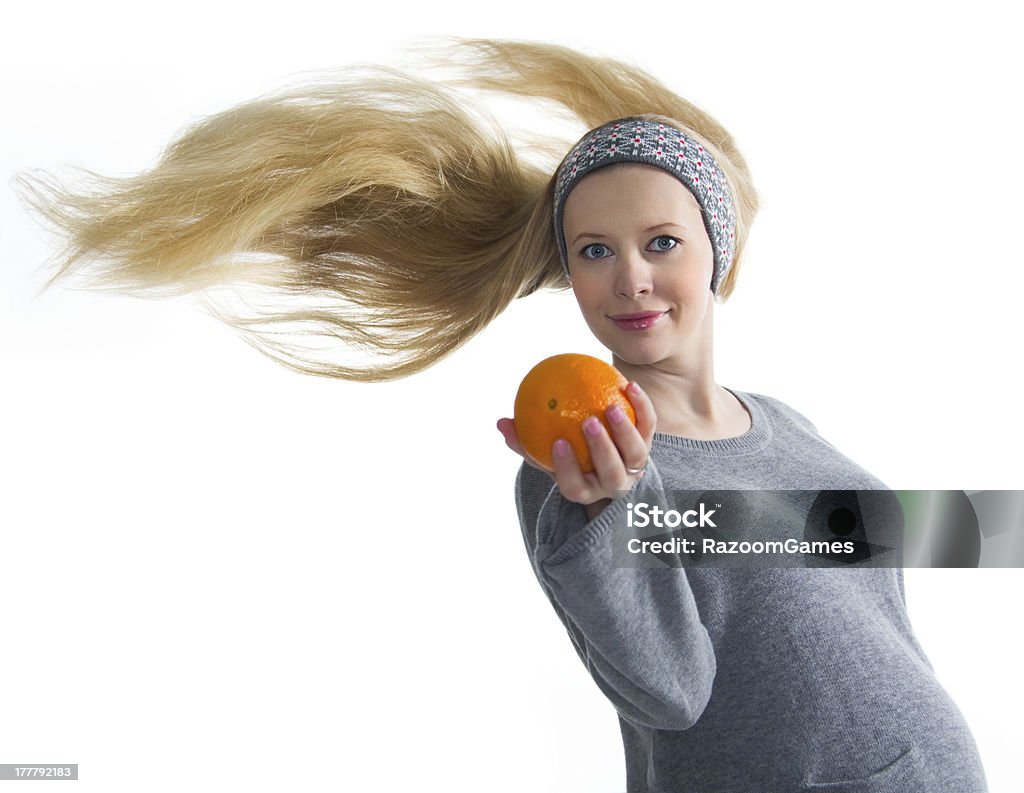 Pregnancy Portrait of pregnant woman with flowing hair and orange in his hand Abdomen Stock Photo