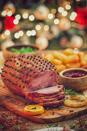 Traditional glazed ham with cloves served for holiday dinner