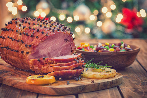 Traditional glazed holiday ham on the wooden background