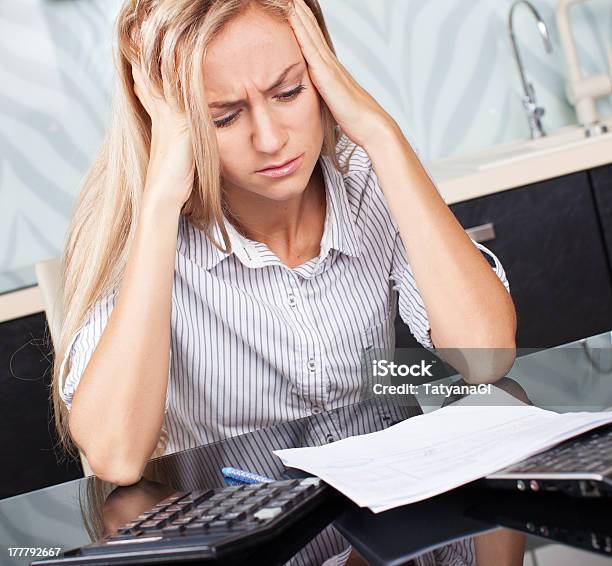 Sad Woman Looks At The Bill Stock Photo - Download Image Now - 25-29 Years, Adult, Adults Only