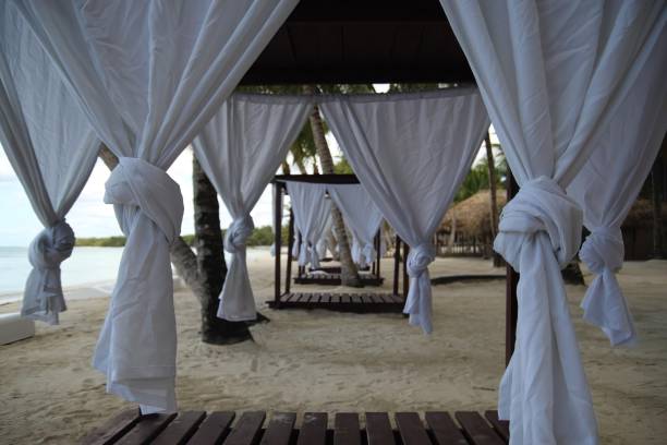 istock Idyllic beach scene with a row of beach beds adorned with white curtains 1777928027