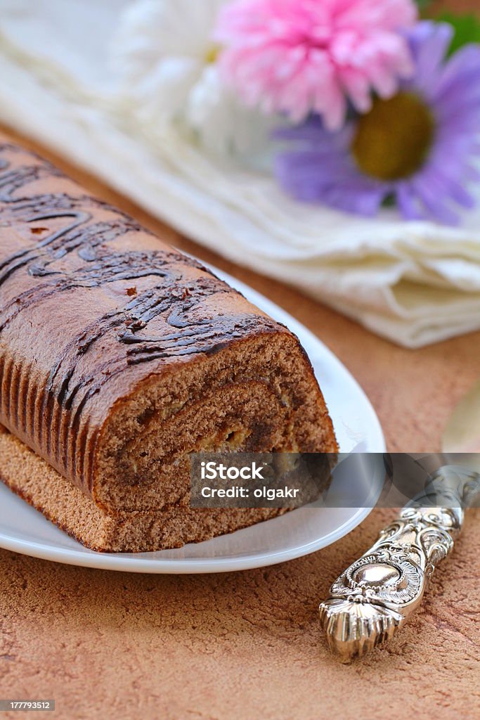 dessert chocolate biscuit roll on a plate Baked Stock Photo