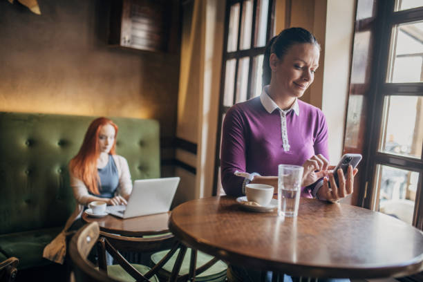 istock Woman using mobile phone while drinking coffee in the coffee shop 1777936443