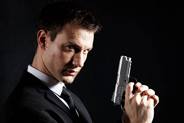 secret agent - bodyguard holding gun 20s stock-fotos und bilder