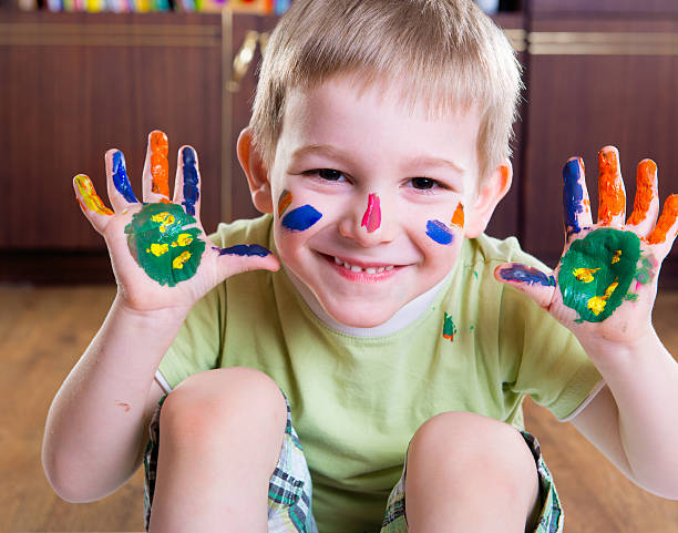 istock Happy boy with colorful  painted hands 177794512