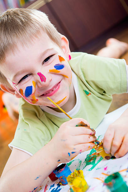 istock Excited little boy painting 177794596
