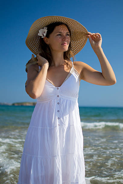 istock Beautiful elegant young woman on the beach 177794641