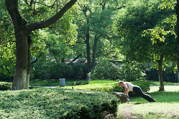 istock man i s doing exercises in the park 177794694