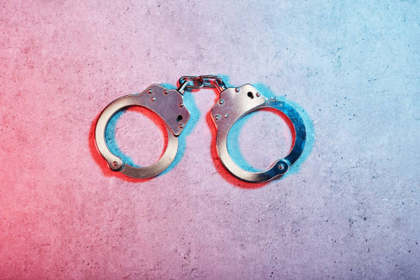 Prisoner with his hands chained isolated on white background.