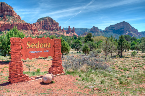 Welcome Sign To Sedona Arizona With A Scenic Background