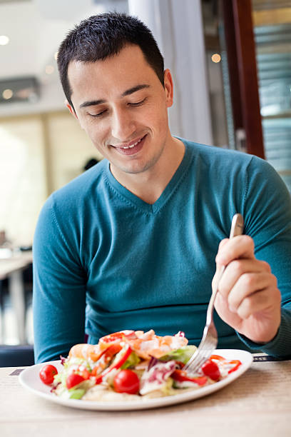 istock Man eating large portion of salad 177795327