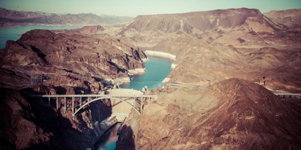 Aerial view of a hydroelectric plant by the Hoover Dam and large Bridge. Rustic digital effect applied to give an old feel to the photo.