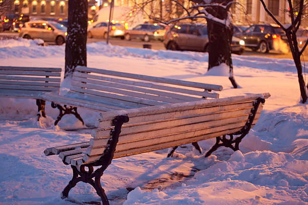 View of bench and illuminated street stock photo