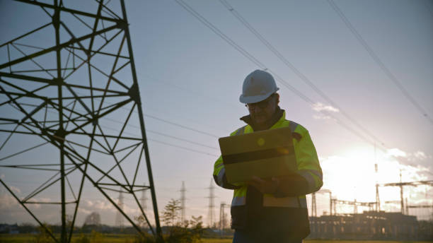 istock Mature Male Electrical Engineer Working On Laptop At Power Station Against Sky During Sunset 1777961840