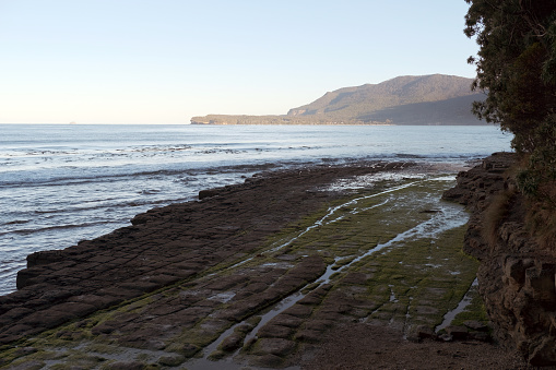 The Tessellated Pavement that is found at Eaglehawk Neck on the Tasman Peninsula of Tasmania. This tessellated pavement consists of a marine platform on the shore of Pirates Bay, Tasmania. This example consists of two types of formations: a pan formation and a loaf formation.