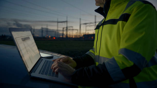 istock Midsection Of Electrical Engineer Using Laptop On Car Hood During Twilight 1777965436