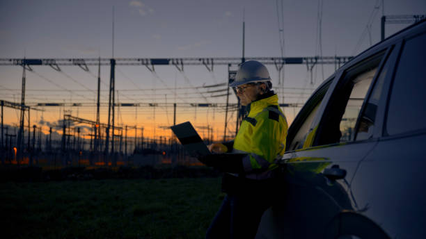 istock Side View Of Male Engineer Using Laptop While Leaning On Car At Power Station During Twilight 1777965470