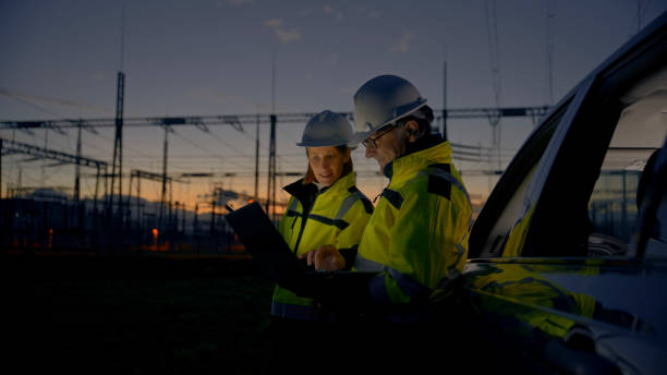 istock Dedicated Male And Female Engineers Using Laptop While Leaning On Car At Dark Power Plant 1777965475