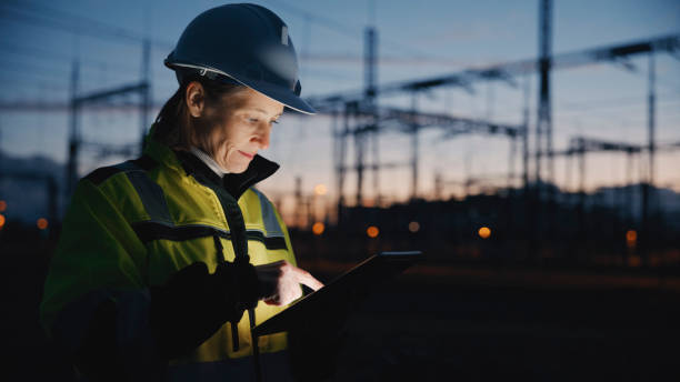 istock Female Electrical Engineer Using Digital Tablet At Dark Power Station During Twilight 1777965990