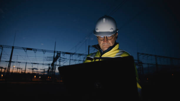 istock Mature Male Electrical Engineer Working On Laptop At Dark Power Plant During Twilight 1777966542