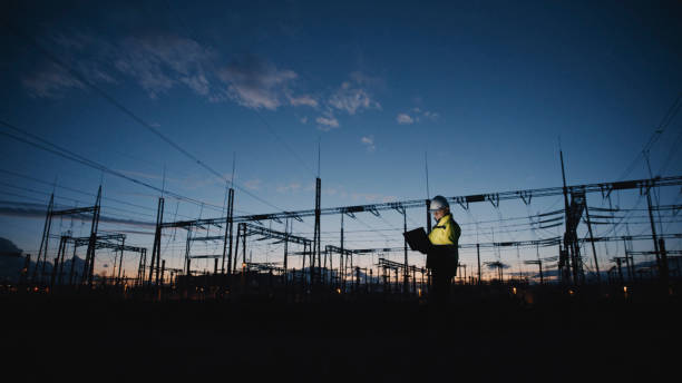 istock Male Electrical Engineer Using Laptop On Silhouette Power Plant At Twilight 1777966544