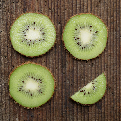 Kiwi slices on wooden table top view