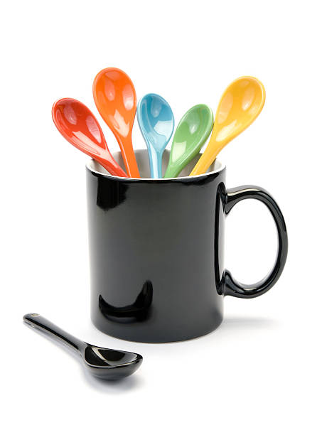 Mug and colorful spoons stock photo