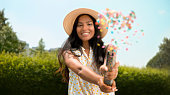 Young woman exploding confetti