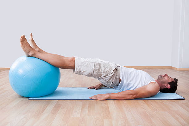 istock Young Man Exercising On A Pilates Ball 177797387