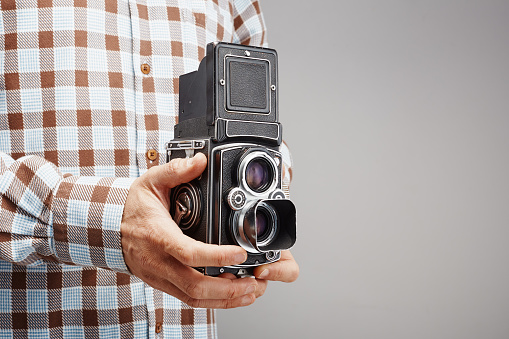 Taking a picture with a vintage twin lens reflex (TLR) medium format camera with waist level finder