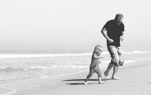 father and daughter on the beach. Black and white photo. 