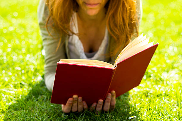 istock Young woman reading in the park 177799160