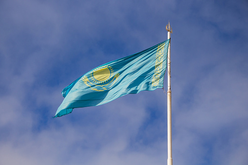 The state flag of the Republic of Kazakhstan fluttering in the wind. Qazaqstan flag