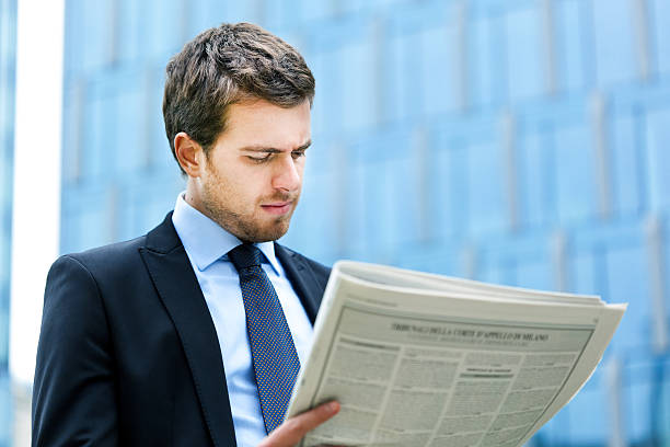 istock Young businessman reading a newspaper 177799323