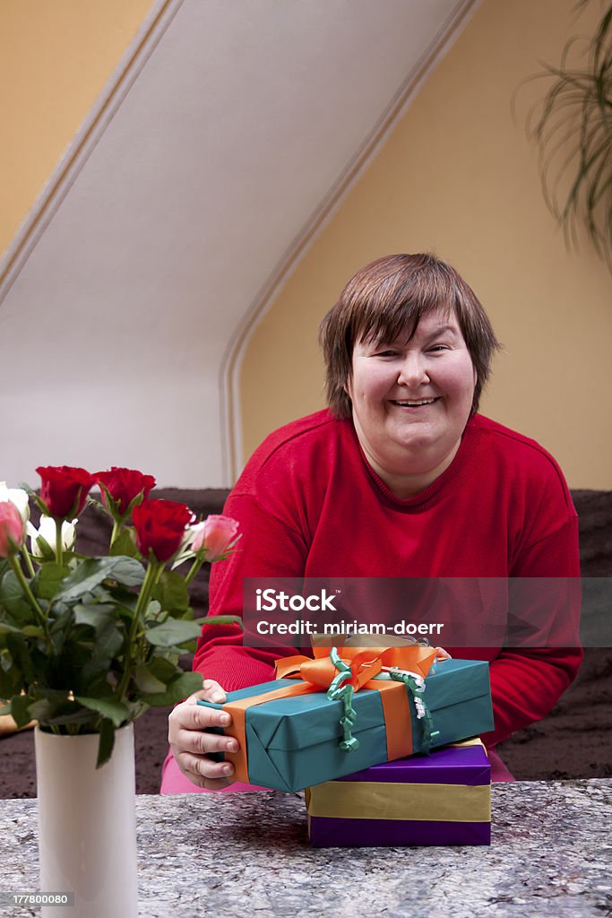 Mentally disabled woman holding many gifts Mentally defective woman holding many gifts Persons with Disabilities Stock Photo
