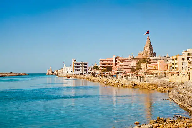 Landscape of Dwarka Bay, Arabian Sea and promenade from the public pathway leading up to the Shree Dwarakadheesh Krishna Temple a significant religious place and pilgrimage for hindus on the coast of Gujarat, India