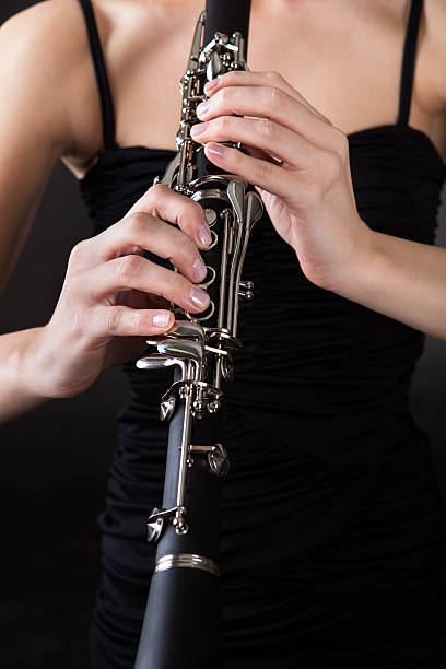 istock Beautiful young woman playing clarinet 177800552