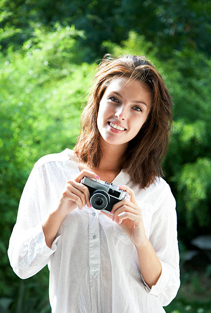 istock Beautiful young woman with retro camera 177800872