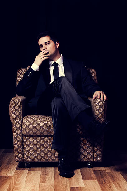 istock Man with cigarette sitting in vintage armchair 177801318