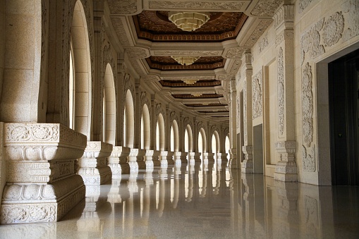An interior view of an ornate corridor decorated with detailed columns at the Usnisa Palace located in Nanjing, China