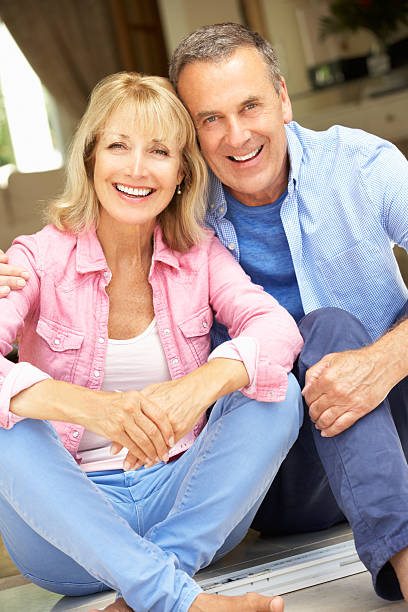 istock Senior Couple Sitting Outside House 177802109