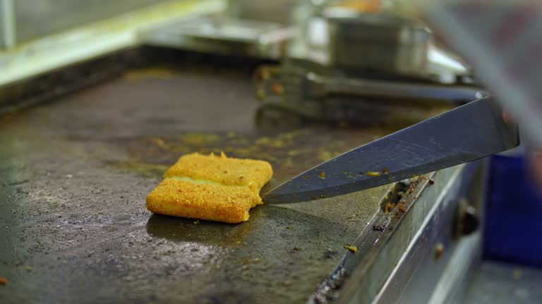 Food Service Worker Preparing Fried Cheese At A Diner