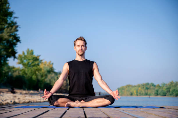istock Mature man doing yoga exercise on jetty 1778025169