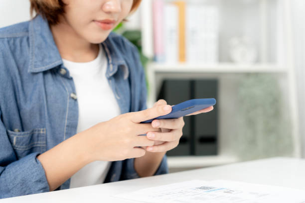 istock woman use phone scan barcode or QR codes to pay credit card bill after receiving document invoice. payment, receive, paying electricity, digital payments, technology, scanning, financial transactions 1778025767