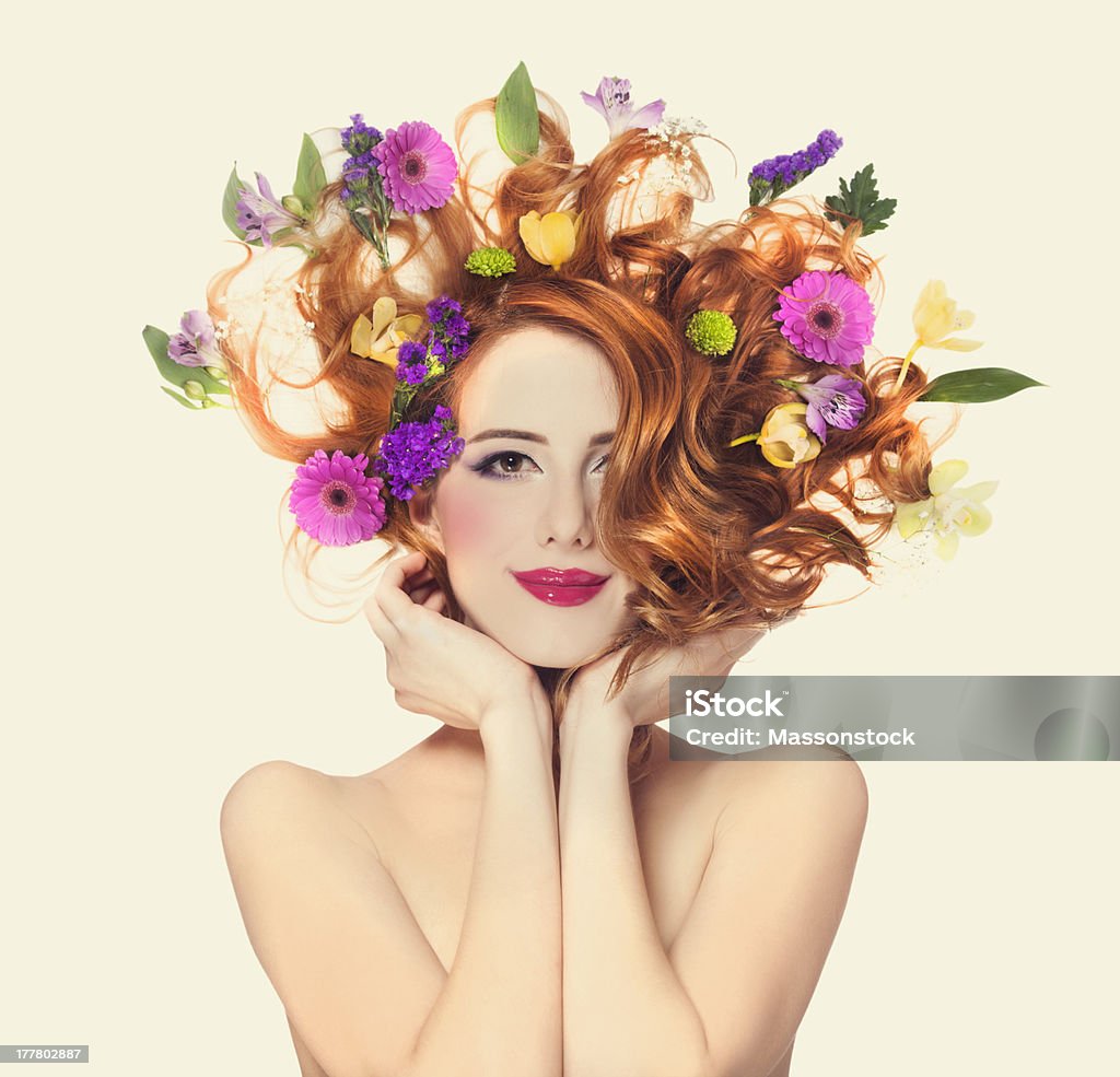 Beautiful redhead girl with flowers isolated. Flower Stock Photo