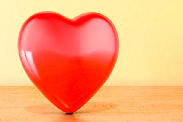 Red heart on the wooden table, 3D rendering