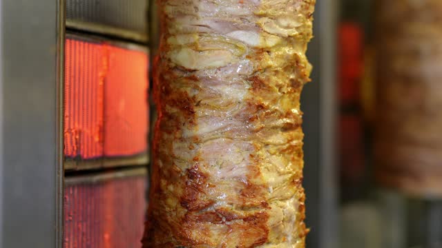 Gyros Meat Being Grilled On A Skewer At A Fast Food Kiosk